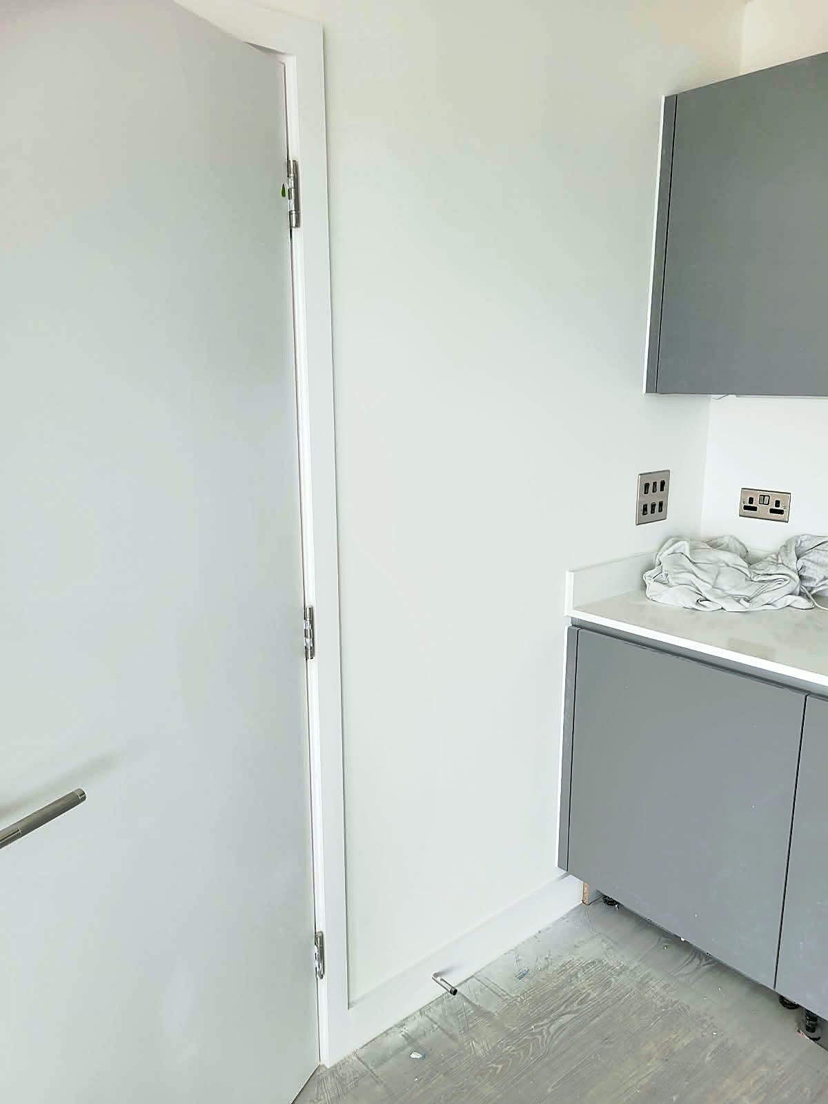 Utility room with white walls and door finished, clean cut-in at the frame
