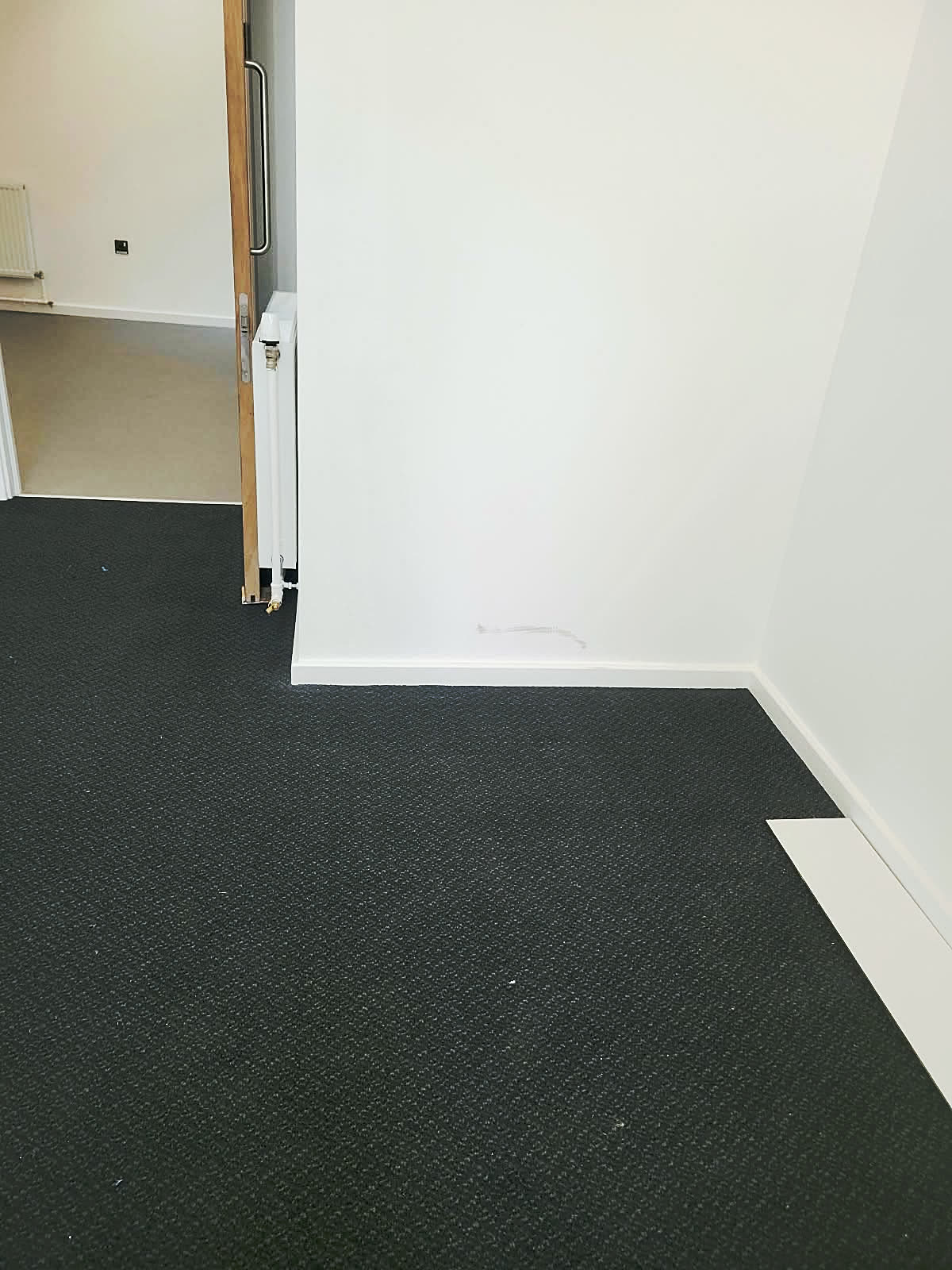 Office room with fresh white walls and skirting, ready for handover